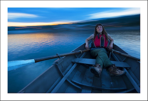 Former North House Folk School intern Emily Derke takes a Norwegian pram out for a paddle in the Grand Marais harbor Saturday night. Photo by Layne Kennedy.