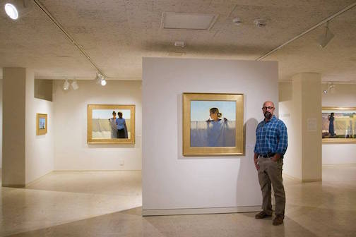 Jeffrey T. Larsen with his exhibit "Domestic Space" at the Tweed Museum of Art.