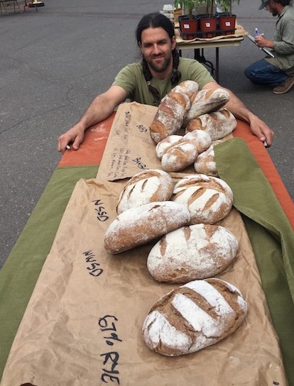 Trevor Huggins sells his wood-fired artisan bread at the Grand Marais Farmer's Market on Thursdays.