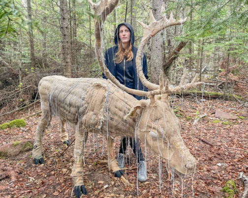 Corrie Steckelberg stands beside her sculpture of the woodland caribou that can be found somewhere in the woods at the Rec Park.