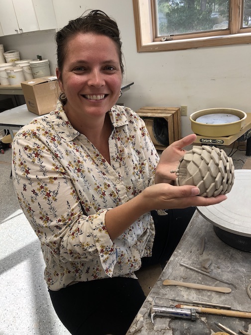 Coreena Affleck with one of her ceramic sculptures she worked on during a residency at the Grand Marais Art Colony recently.