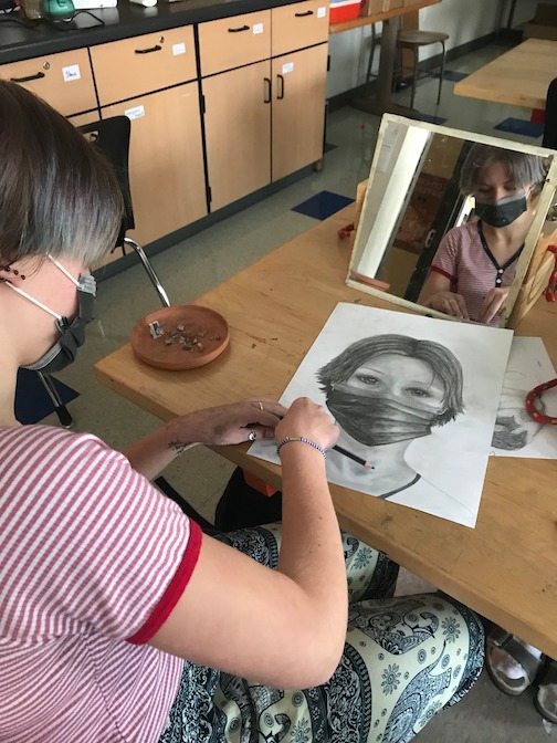 Siena, a 10th grader at ISD 166, works on her self-portrait.