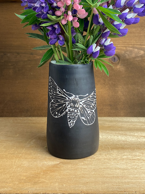 Black stoneware vase with slip trailed moth image by Adfrea Beres. She is one of the artists participating in the Fall 'studio Tour.