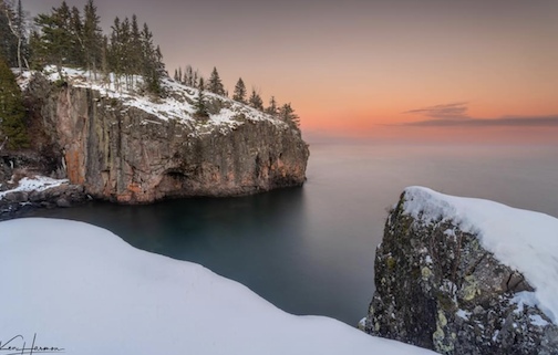 Dusk, snow trimmed rocky rugged shoreline of Lake Superior, by Ken Harmon.