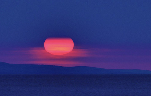 A smokey sunrise over the Big Lake by Chuck Olsen.