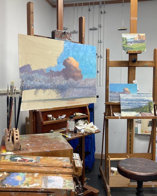 Studio painting. Blocking in the clouds, by Neil Sherman.