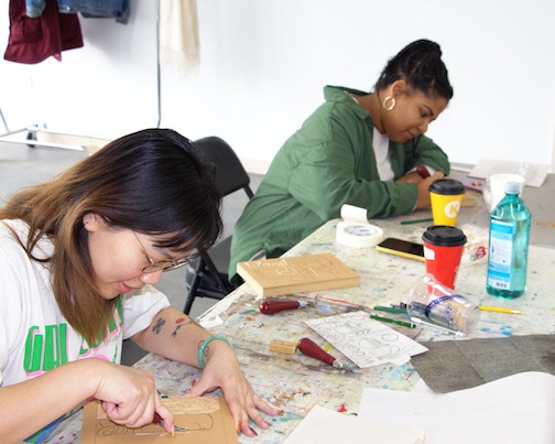 Artists Genie Hien Tran and Leeya Rose Jackson carve blocks during a printmaking workshop during their residency at the Art Colony. An Open /studio wil be held in the Founders Hall for them on /Friday.