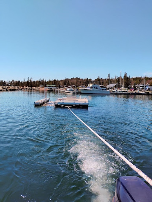 The accessible kayak dock was towed across the bay to its summer home at the Parkside public water accessPhoto courtesy of the City of Grand Marais.