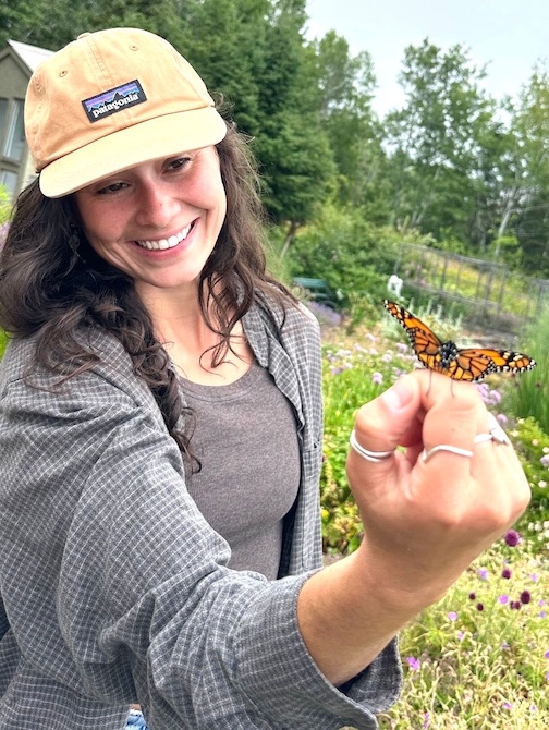 Emily Butterfly, raised by Maryl Skinner and Denny Fitzpatrick, pauses a moment on Emily Harman's hand before flying away to her new life. Photo by Maryl Skinner.