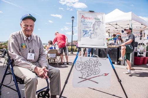 David Hahn taught art to children for years. In this photo, he is set up to draw portraits at the Grand Marais Arts Festival. (File Photo)