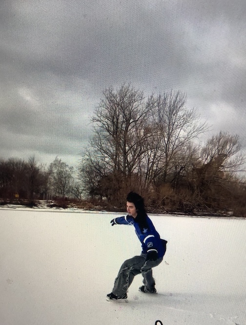 Alexei in hockey skates on a snow-covered lake. Click here to watch.