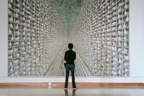 A spectator views a painting by ,by Doug Argue at the Weiseman Art Museum.