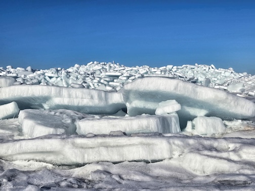 Chunks are mounting up on the shore, Duluth, by Marie Zhuikov.