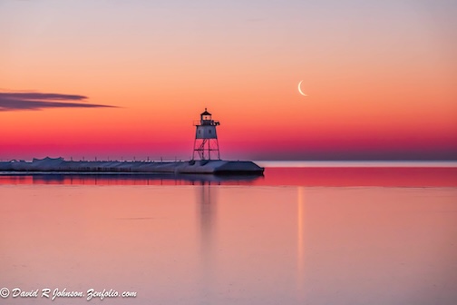 Sunrise waning crescent moon at Grand Marais by David Johnson.