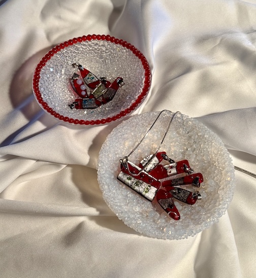 Bowls and pendants of fused glass, frit balls, and silver by Tony Rau.