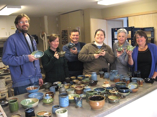 Blast from the past. Pottery class at the GrandMarais Art Colony celebrates a kiln opening several years ago.